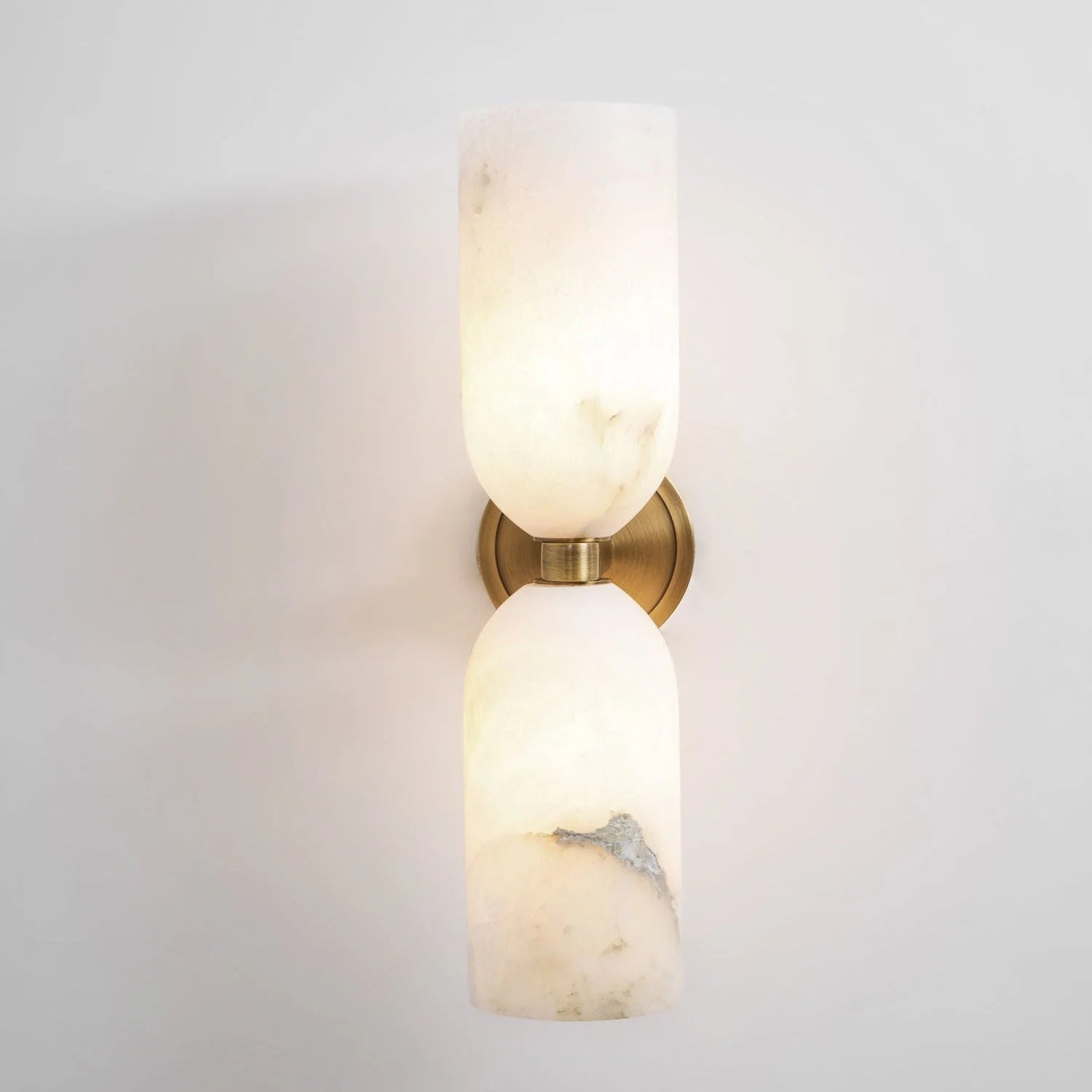 Alabaster wall light featuring an elegant up and down glow design, available in copper, black, or bronze finishes, perfect for modern home decor. 0