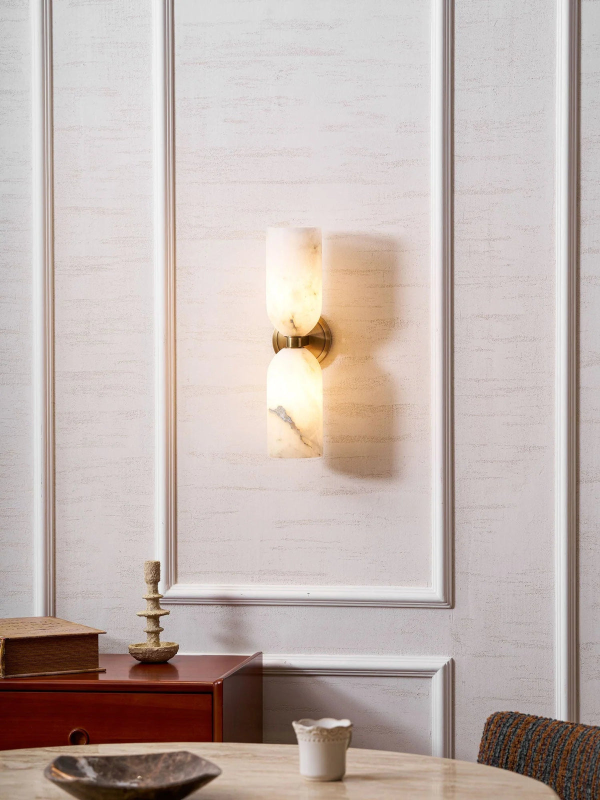 Alabaster wall light featuring an elegant up and down glow design, available in copper, black, or bronze finishes, perfect for modern home decor. 8