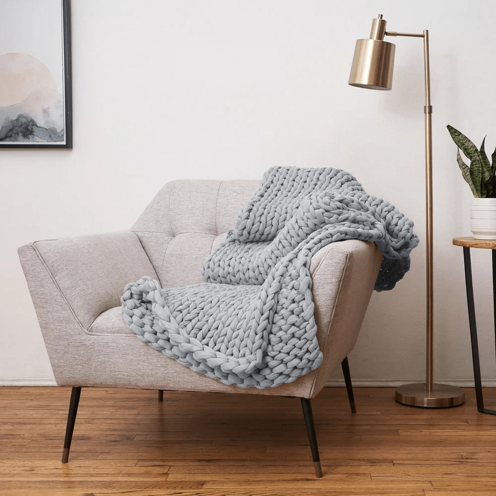 Cooling weighted blanket featuring a knit chunky design, made from breathable TENCEL™ fabric, available in various colors for enhanced comfort and style. 8