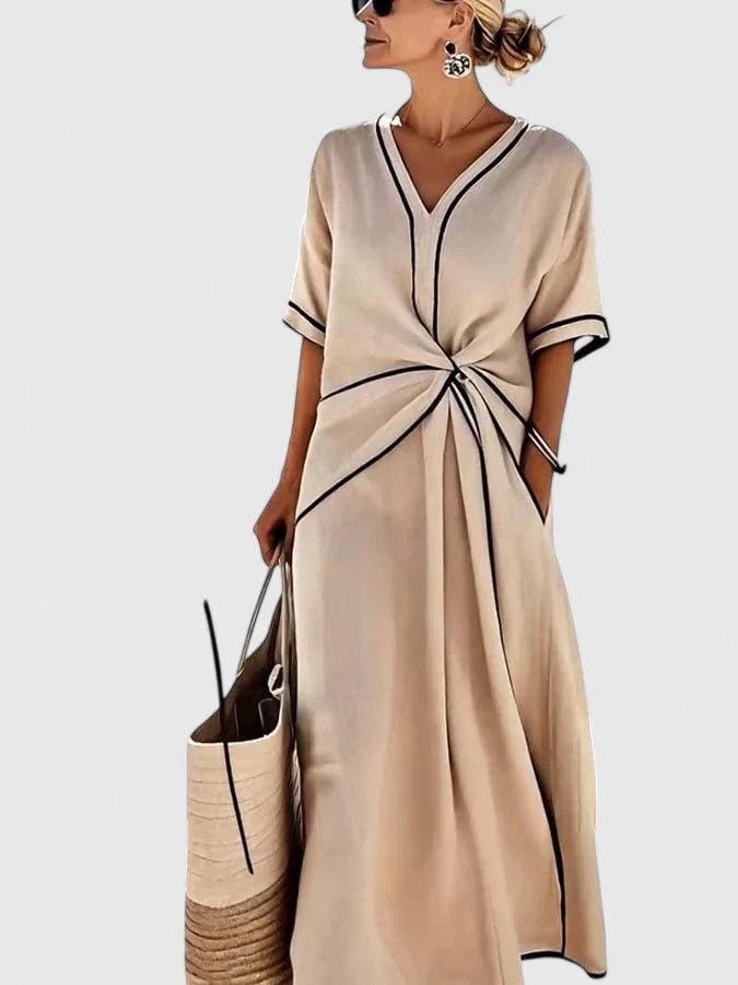Elegant summer dress featuring vertical stripes, designed for a lightweight and breathable feel, perfect for warm weather occasions. 3