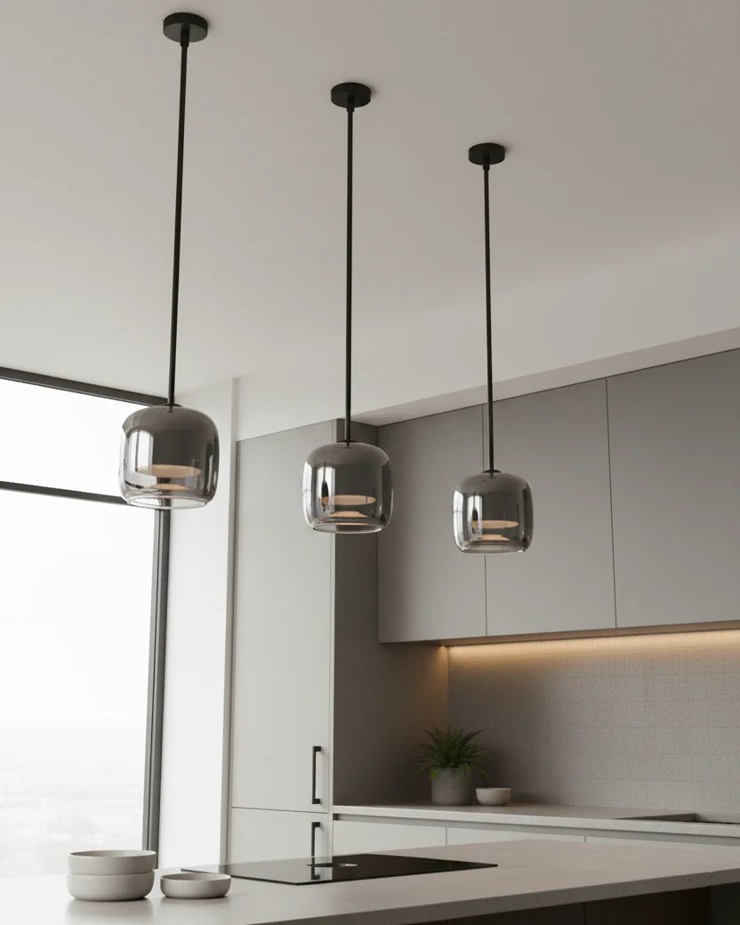 Modern globe pendant light featuring a smoky glass shade and sleek black metal finish, perfect for stylish kitchen lighting with integrated LED technology. 7