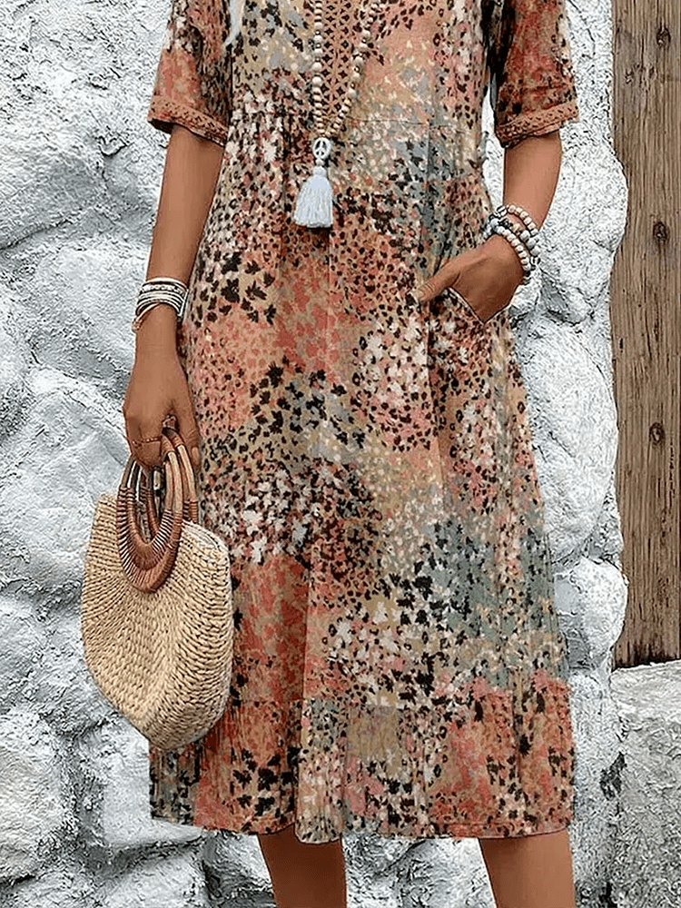 Knee-length V-neck summer dress featuring a vibrant floral pattern and convenient side pockets, designed for comfort in plus sizes. 6