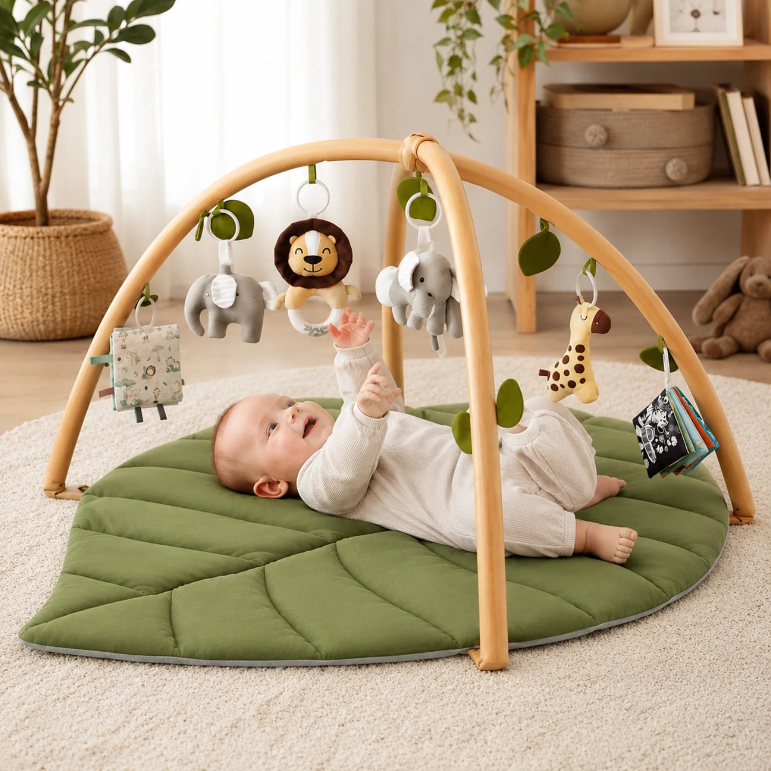 Leaf-shaped baby play gym featuring colorful detachable toys, designed for tummy time with a soft padded mat suitable for newborns and infants. 0