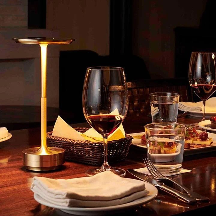 Portable cordless table lamp with adjustable brightness, featuring a sleek metallic finish, ideal for both indoor and outdoor use. 0