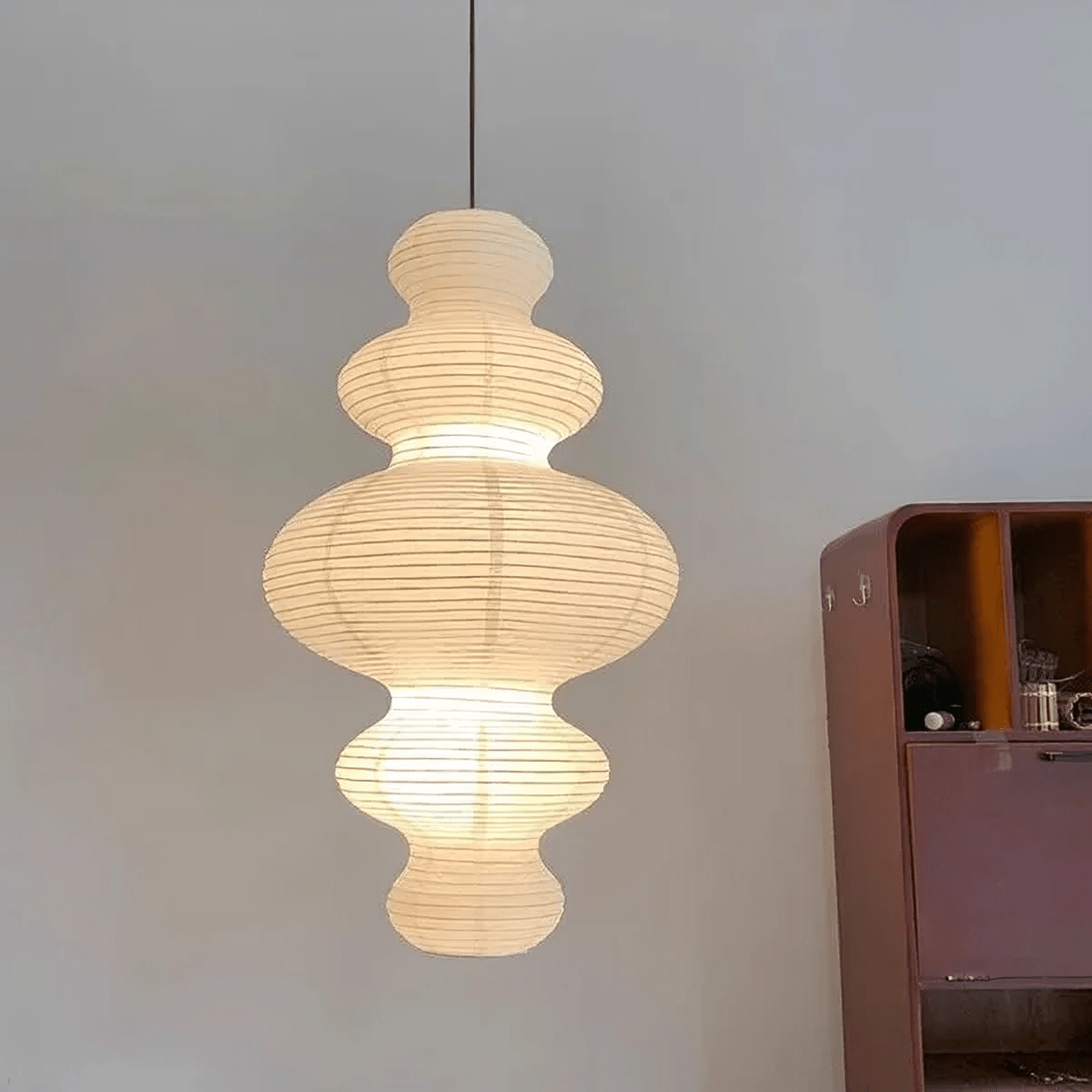 Rice paper hanging lamp featuring a minimalist design, adjustable height, and multi-layer structure, perfect for enhancing the ambiance in kitchens and dining areas. 3