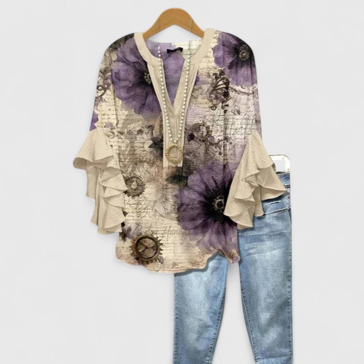Womens blouse with ruffled sleeves and a vibrant floral print, designed as a lightweight summer top for women, perfect for casual outings and warm weather. 9
