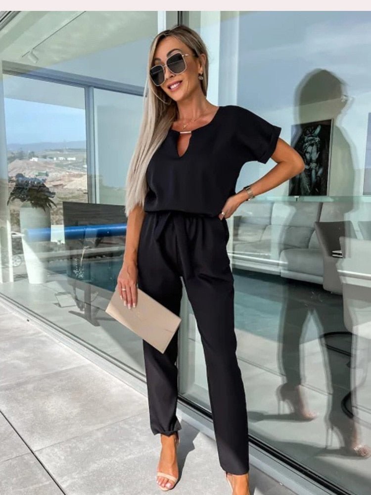 Women's elegant black jumpsuit featuring a flattering V-neckline and comfortable elastic waistband, perfect for transitioning from day to night. 9