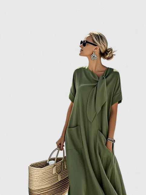 Womens summer dress featuring a chic neck tie and pockets, designed with elegant lightweight white fabric, perfect for warm weather outings. 4