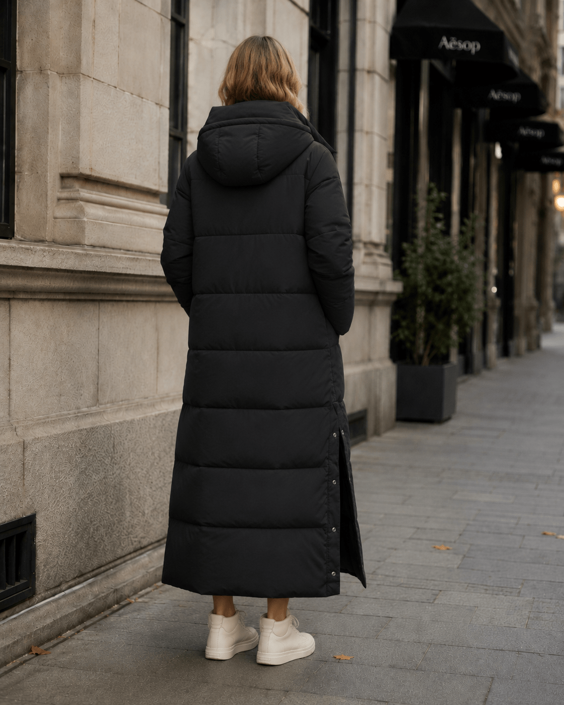 Women's windproof winter jacket featuring an extended length and relaxed fit, designed for durability and warmth in cold weather conditions. 4