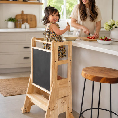 Adjustable wooden learning tower for toddlers featuring a Montessori-inspired design, 3-in-1 functionality, and a natural finish, ideal for promoting independence and 0