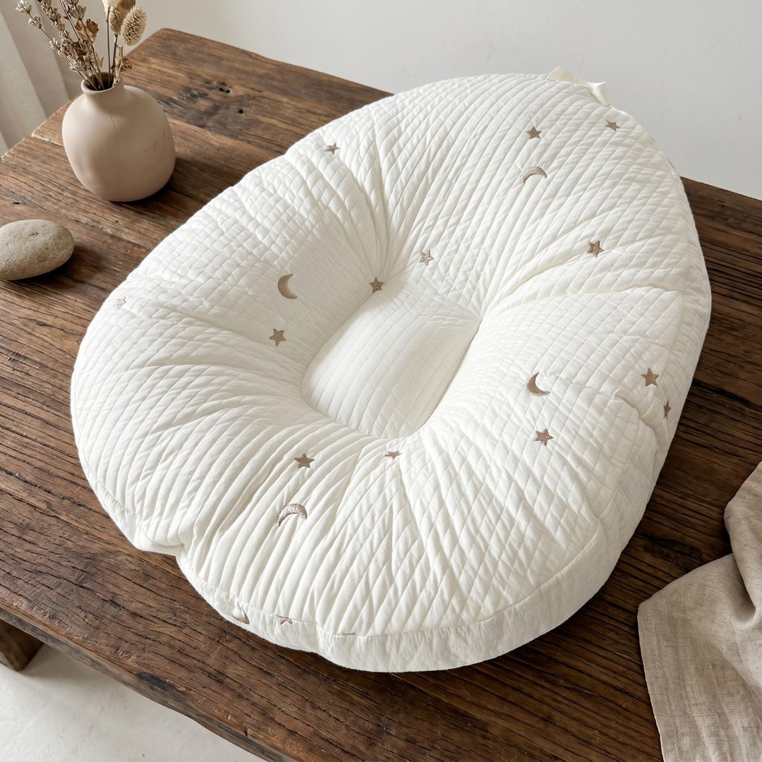 Baby lounger featuring ergonomic support, made with breathable cotton fabric, designed in a soft nest shape for optimal comfort and safety for infants. 8