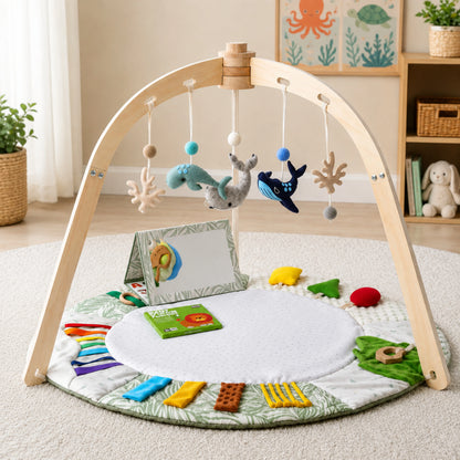 Baby play gym featuring a sensory activity mat and natural wooden frame, designed in a vibrant multi-color scheme for tummy time and exploration. 1
