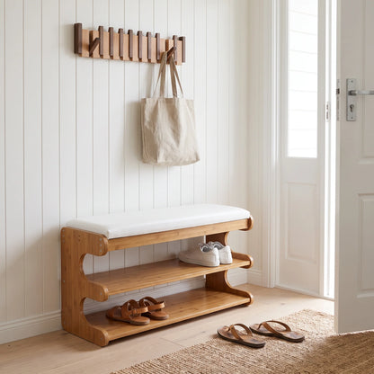 Bamboo shoe storage bench with padded seat in natural finish, featuring a space-saving design ideal for entryway organization. 0