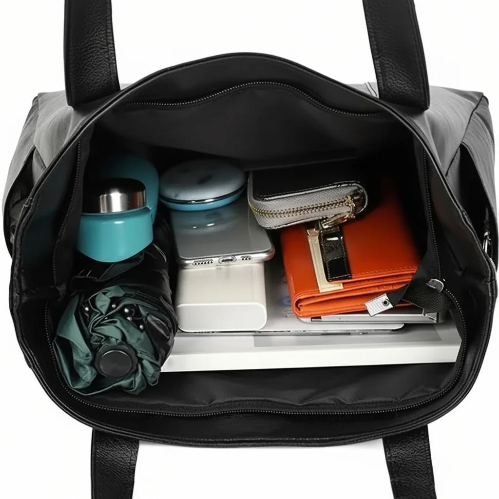 Black shoulder bag made of PU leather featuring organized storage compartments and a secure zip closure, designed for everyday use by women. 5