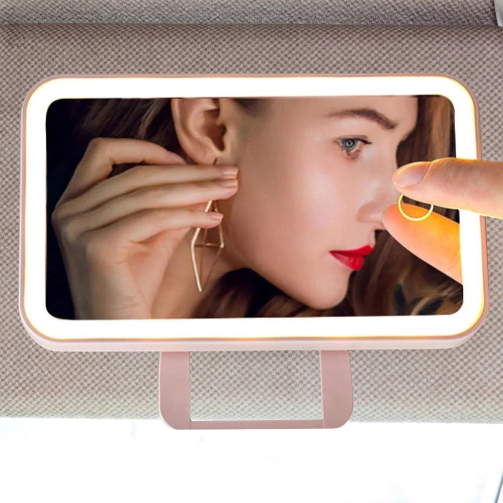 Car visor makeup mirror featuring three color LED lights and adjustable brightness, designed in a compact pink and white ABS casing. 0