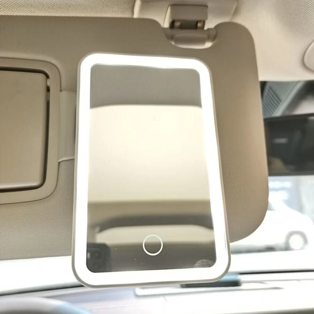 Car visor makeup mirror featuring three color LED lights and adjustable brightness, designed in a compact pink and white ABS casing. 1