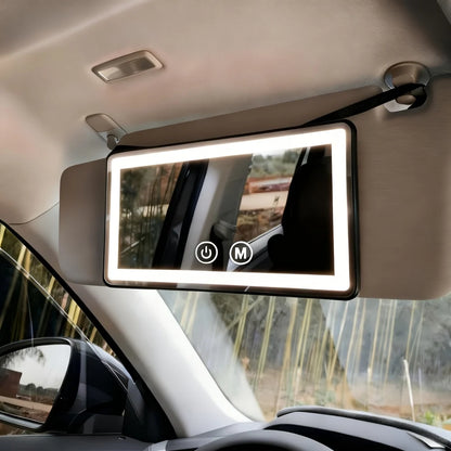 Car visor mirror with dimmable LED lighting, adjustable makeup mirror for on-the-go grooming, featuring a sleek black plastic and glass design. 1