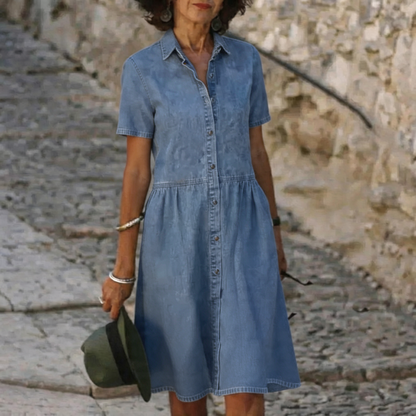 Denim dress for women featuring a button-front design and A-line hem, made from soft washed denim, perfect for everyday wear. 0