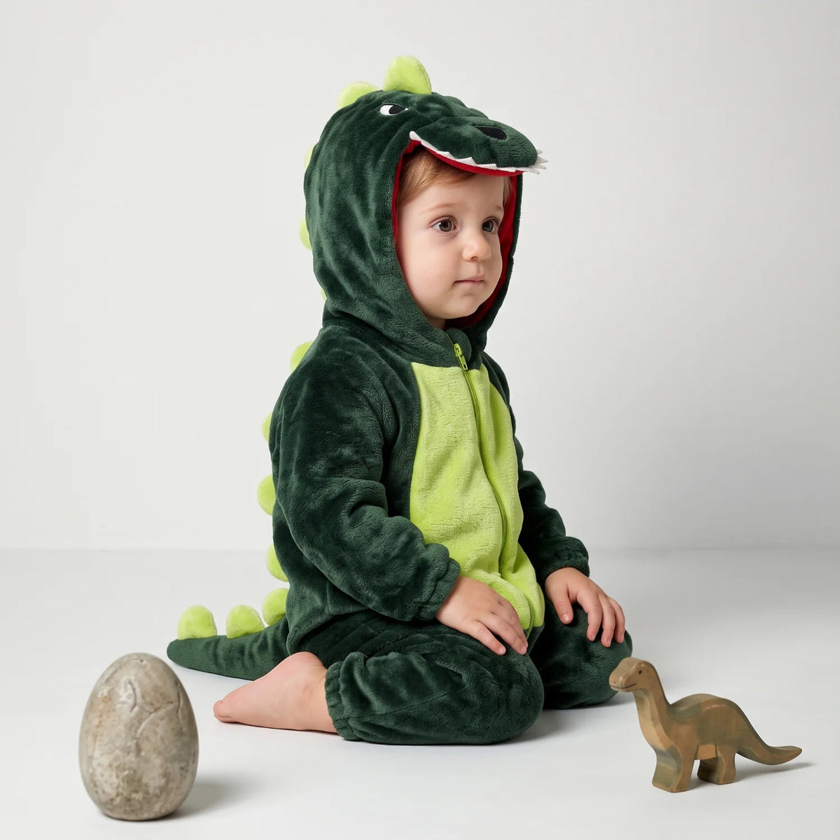 Dinosaur fleece baby romper featuring a spiny hood and full-length zip, made from soft flannel for cozy comfort. 3