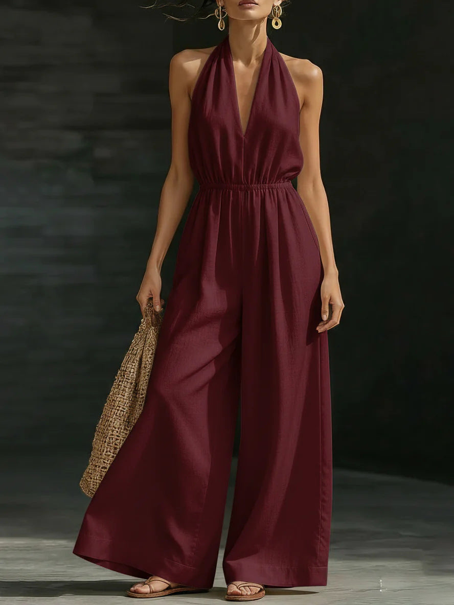 Elegant wide-leg jumpsuit featuring a lace overlay and adjustable halter tie, designed for women in soft, breathable fabric. 0