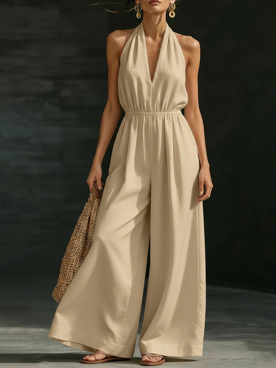 Elegant wide-leg jumpsuit featuring a lace overlay and adjustable halter tie, designed for women in soft, breathable fabric. 1