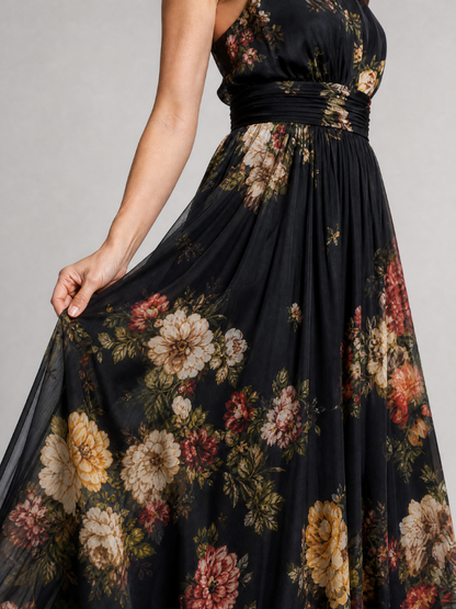 Floral midi dress featuring a defined waist and halter neck, designed for summer weddings, made from lightweight, flowing fabric. 1
