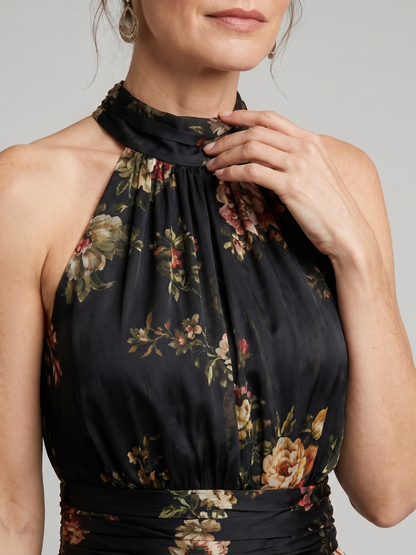Floral midi dress featuring a defined waist and halter neck, designed for summer weddings, made from lightweight, flowing fabric. 2