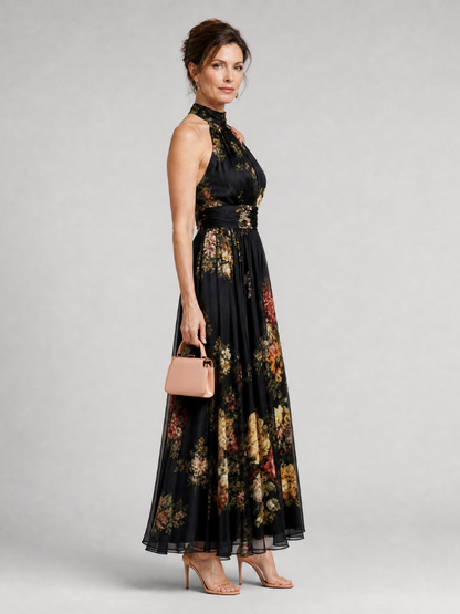 Floral midi dress featuring a defined waist and halter neck, designed for summer weddings, made from lightweight, flowing fabric. 3