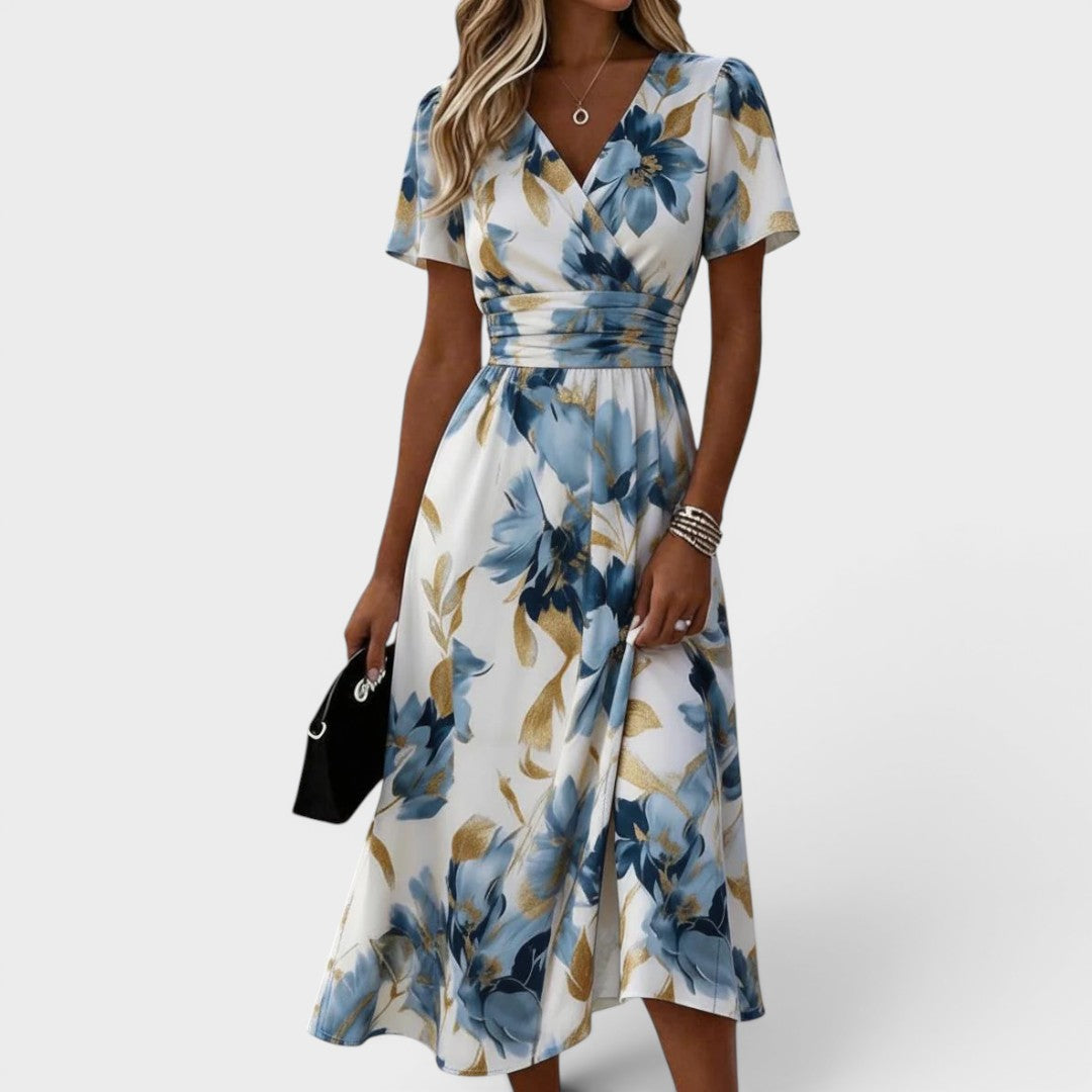 Floral wrap midi dress featuring a ruched waist and gold accents, perfect for summer weddings and elegant occasions. 0