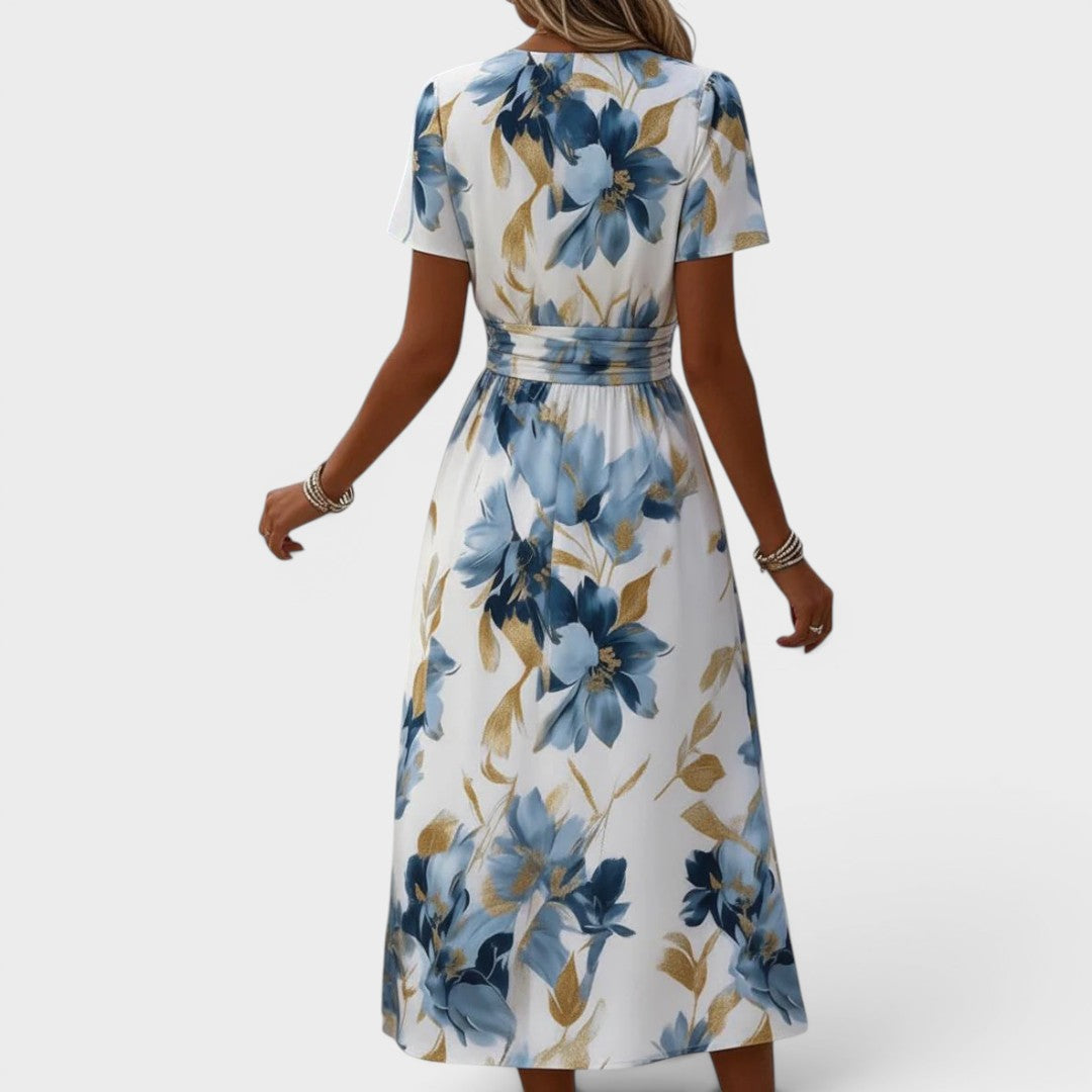 Floral wrap midi dress featuring a ruched waist and gold accents, perfect for summer weddings and elegant occasions. 3