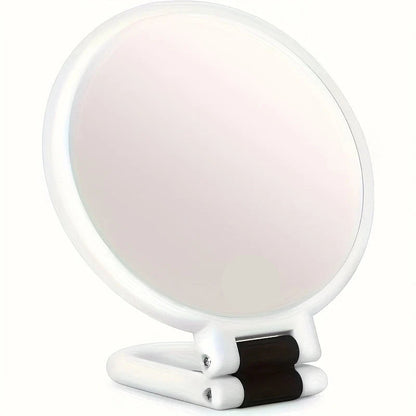 Handheld makeup mirror featuring 30X/40X magnification and a 360-degree folding handle, designed in a sleek black and white plastic finish 0
