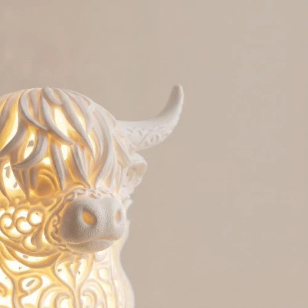 Highland Cow Table Lamp featuring a warm LED glow and intricate filigree design, perfect for adding charm to your bedroom or desk, powered by USB 3
