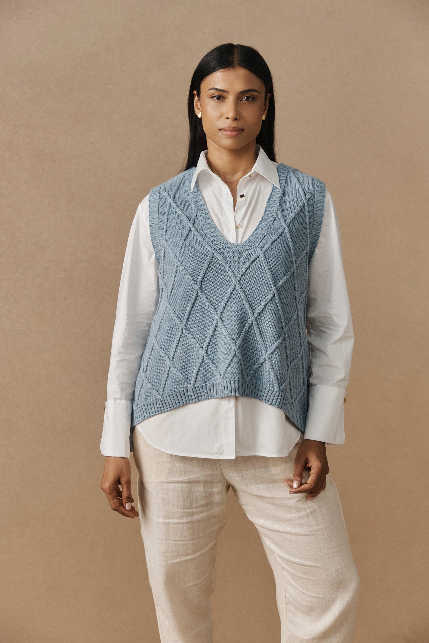 Ladies knitted vest featuring a stylish checkerboard pattern, crafted from breathable cotton with a V-neck design, perfect for layering in any season. 1