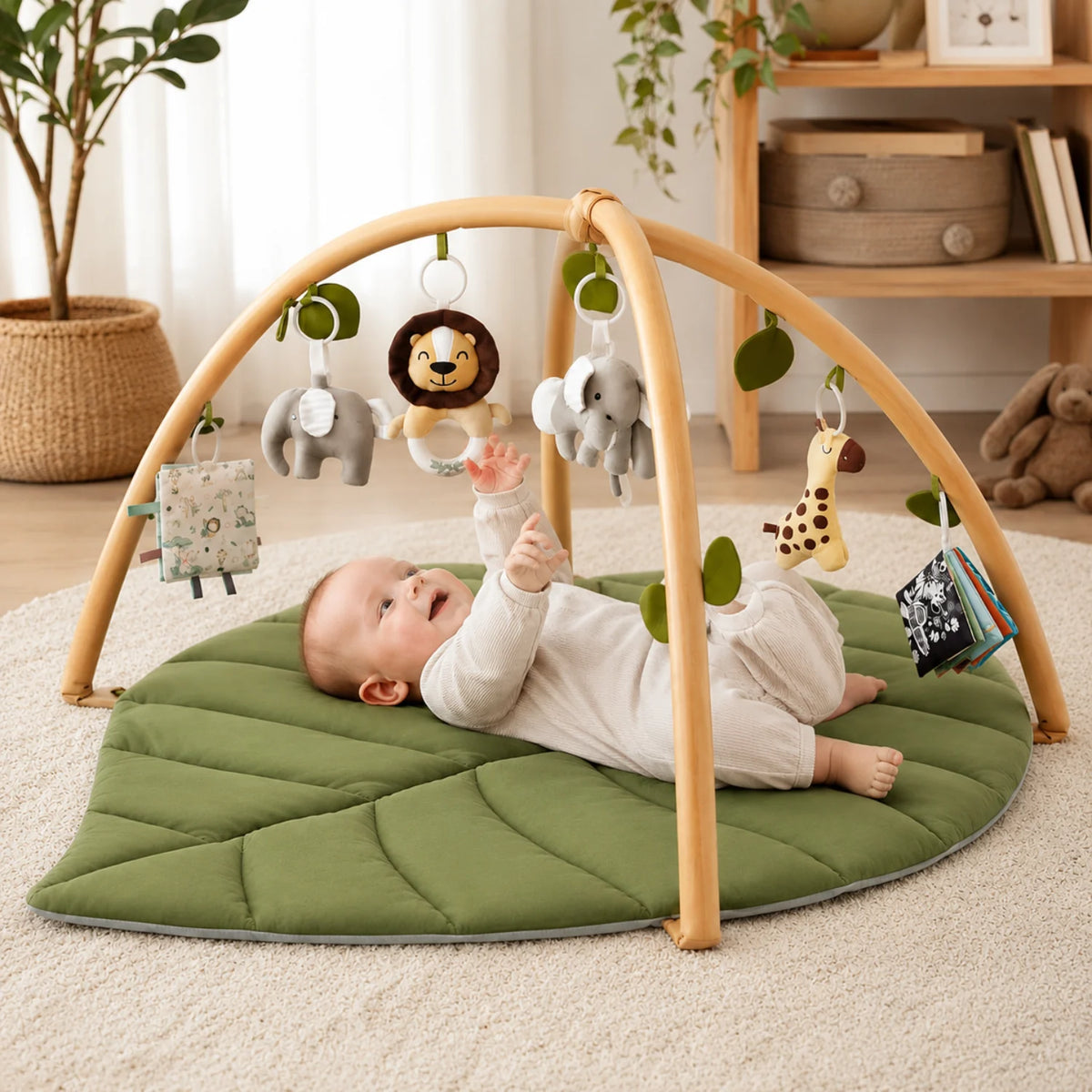 Leaf-shaped baby play gym featuring colorful detachable toys, designed for tummy time with a soft padded mat suitable for newborns and infants. 0