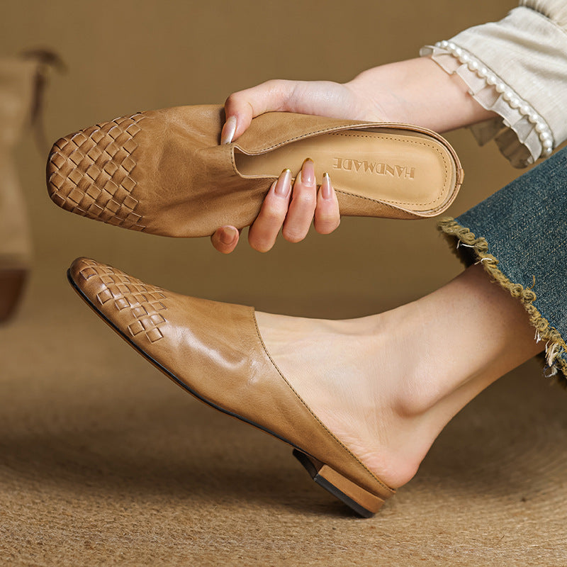 Black leather mules featuring a cushioned insole and woven finish, designed with a square-toe heel for stylish comfort. 0