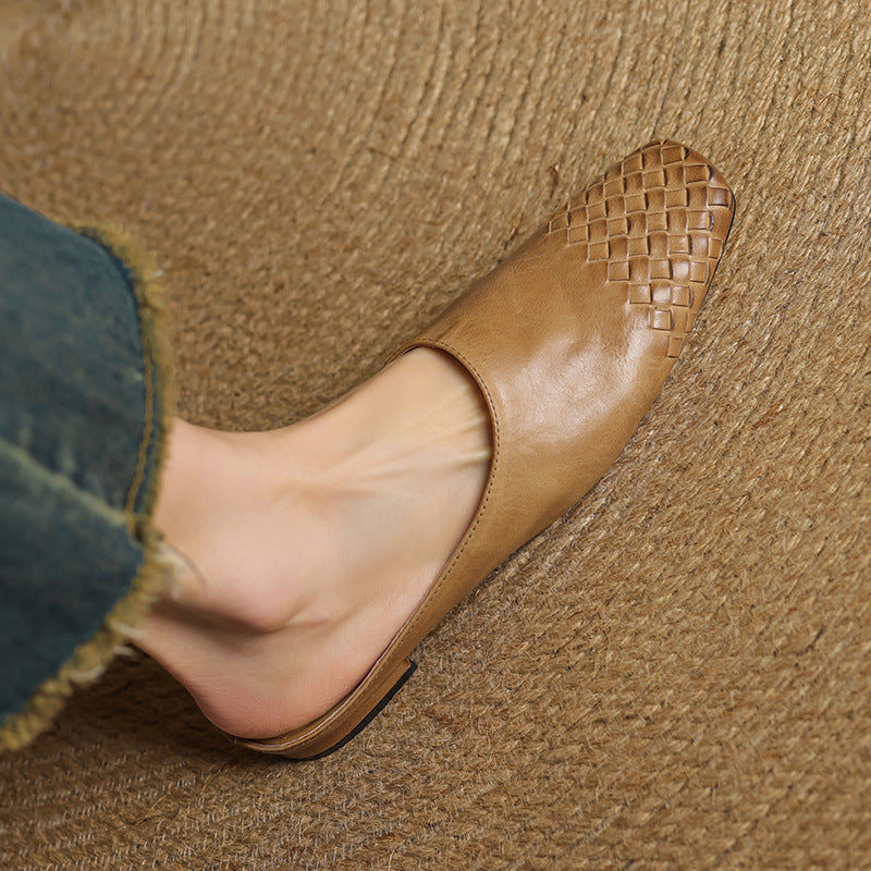 Black leather mules featuring a cushioned insole and woven finish, designed with a square-toe heel for stylish comfort. 1