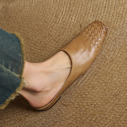 Black leather mules featuring a cushioned insole and woven finish, designed with a square-toe heel for stylish comfort. 1