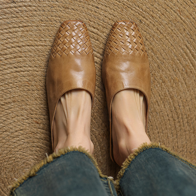 Black leather mules featuring a cushioned insole and woven finish, designed with a square-toe heel for stylish comfort. 2