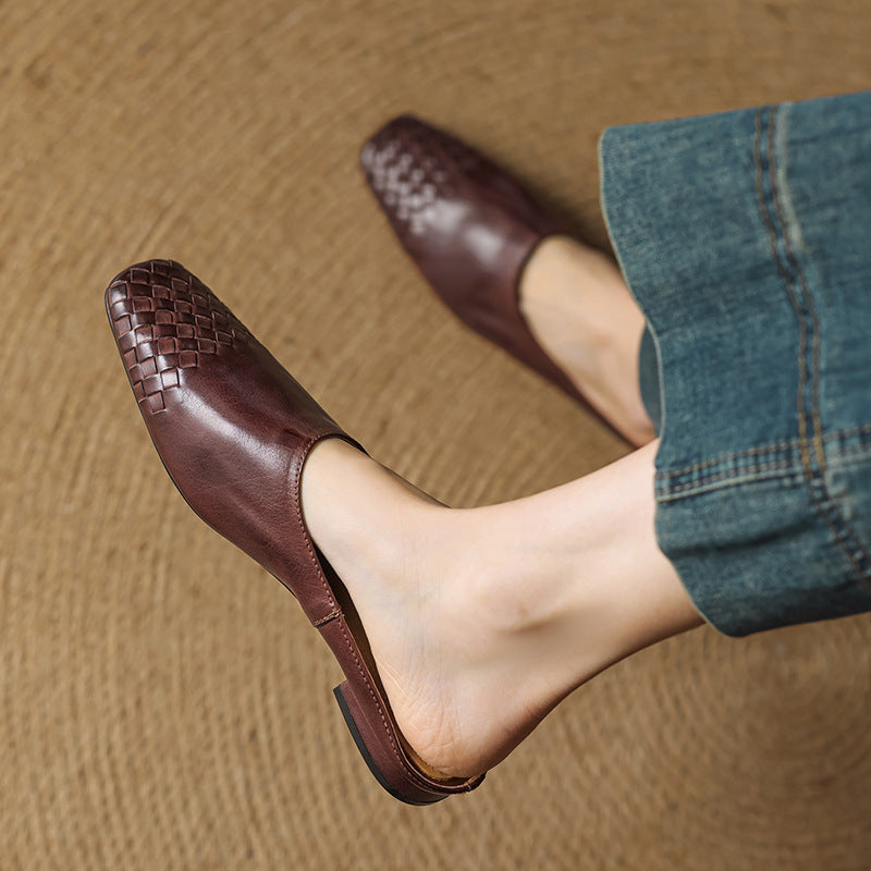 Black leather mules featuring a cushioned insole and woven finish, designed with a square-toe heel for stylish comfort. 7