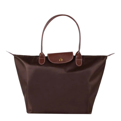 Leather tote bag featuring water-resistant material and a spacious design, perfect for stylish everyday use. 3