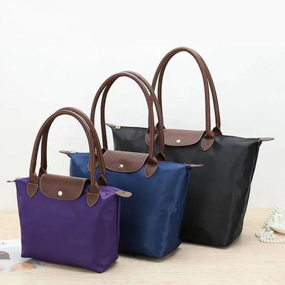 Leather tote bag featuring water-resistant material and a spacious design, perfect for stylish everyday use. 7