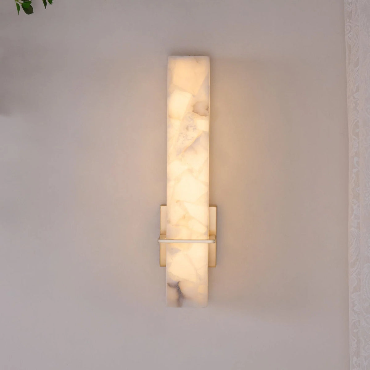Modern linear wall light featuring an elegant alabaster diffuser, available in dimmable brass or nickel finish, designed to enhance ambient lighting in contemporary interiors. 4