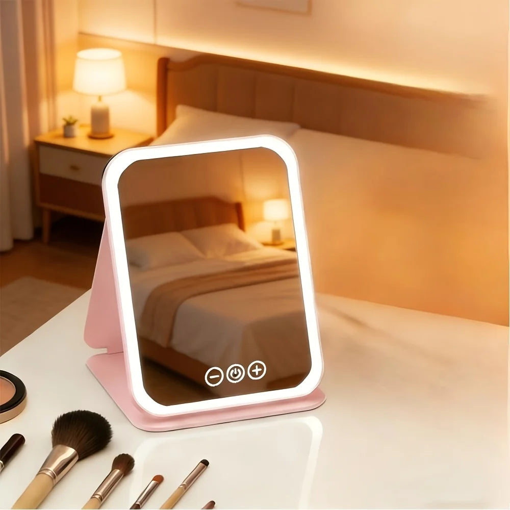 Portable pink plastic makeup mirror with touch control light, featuring a sleek design and adjustable brightness for optimal lighting during makeup application. 3