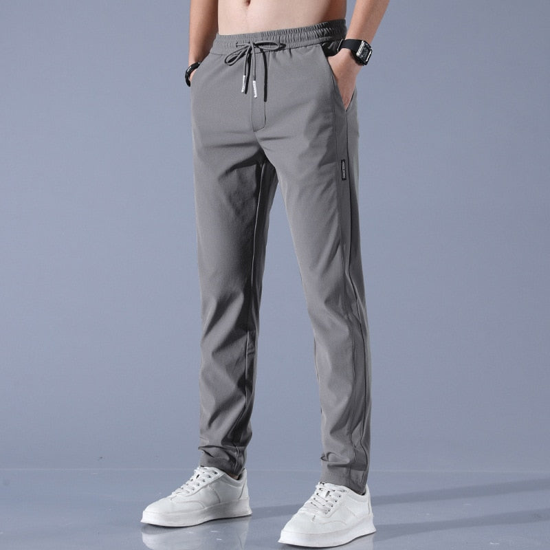 Men's quick-dry stretch trousers with drawstring, designed for comfort and flexibility in outdoor activities, featuring soft activewear fabric for optimal performance. 2