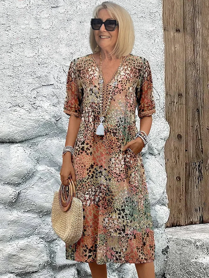 Midi dress featuring an abstract print and lace V-neck, designed for a soft, breathable casual style, complete with convenient side pockets. 1