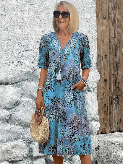 Midi dress featuring an abstract print and lace V-neck, designed for a soft, breathable casual style, complete with convenient side pockets. 3
