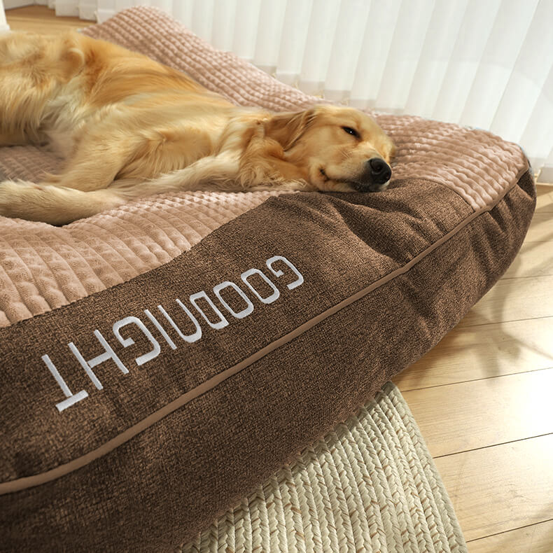 Orthopedic dog bed featuring a raised pillow and soft velor cover, designed for joint support and comfort for pets. 4