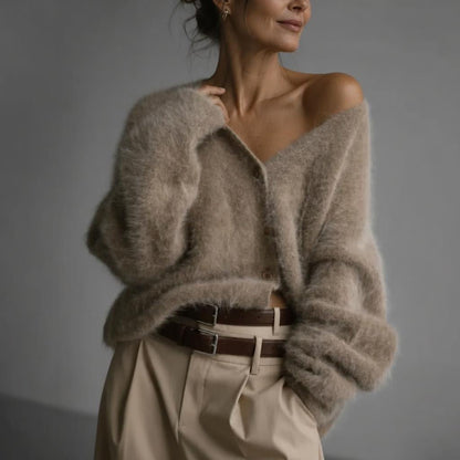 Oversized women's cardigan featuring a deep V-neck and relaxed fit, made from soft knit fabric, perfect for layering. 0