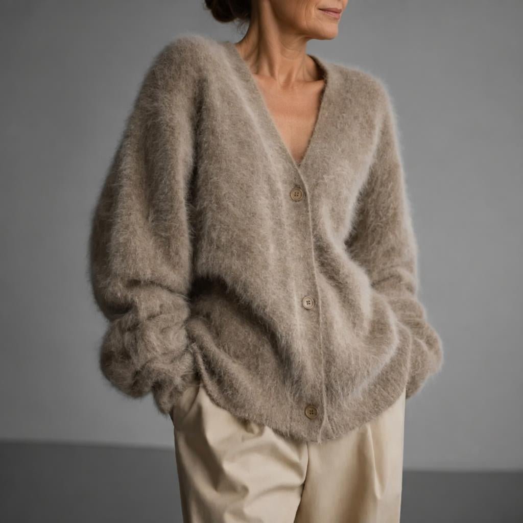 Oversized women's cardigan featuring a deep V-neck and relaxed fit, made from soft knit fabric, perfect for layering. 4