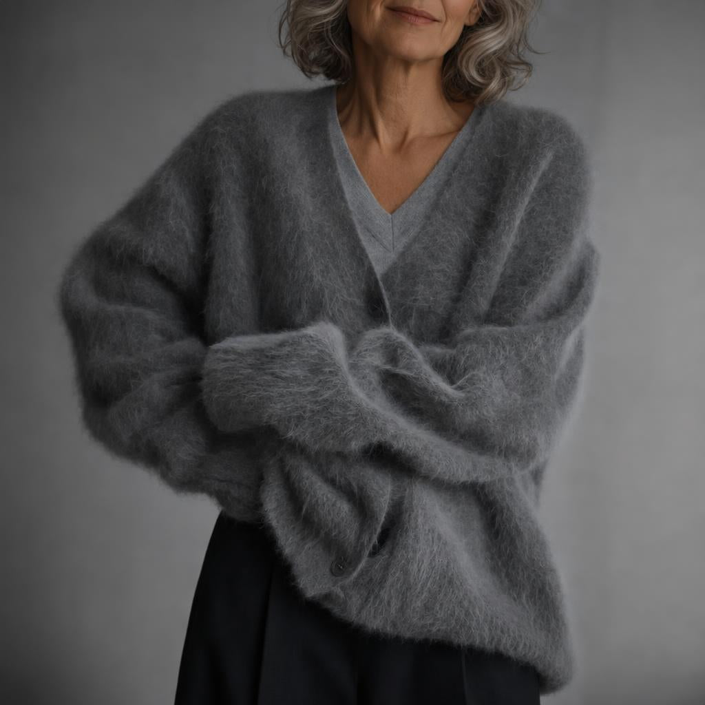 Oversized women's cardigan featuring a deep V-neck and relaxed fit, made from soft knit fabric, perfect for layering. 7